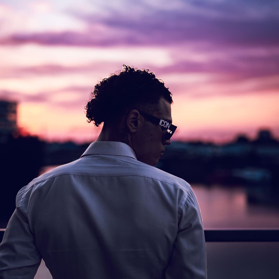 Looking over shoulder with sunset in the background - Holy Infa